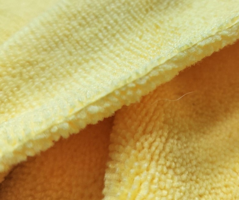 Selecting a thick microfiber towel for spray wax buffing"