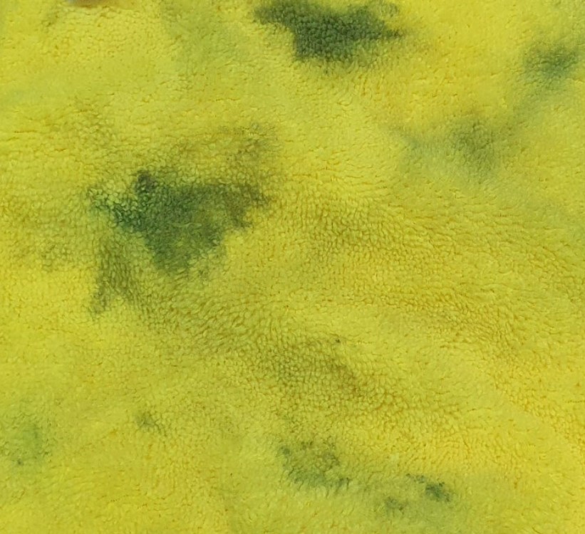Towel test failure showing dark road film on microfiber towel after washing
