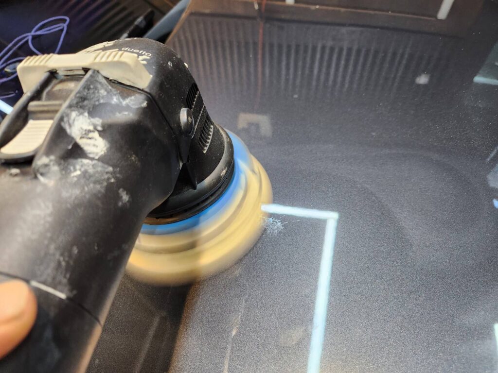 Polishing car paint with a machine polisher and compound to reduce clear coat etching