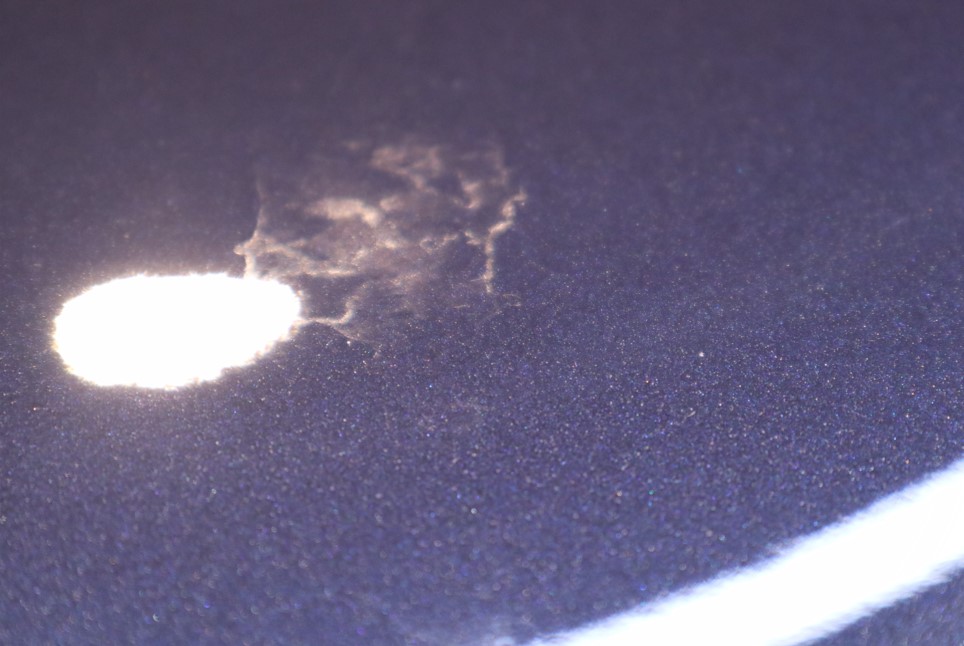 Car paint etching left by concentrated water-spot deposits